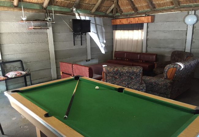 Lounging area with pool table, TV and fooseball table